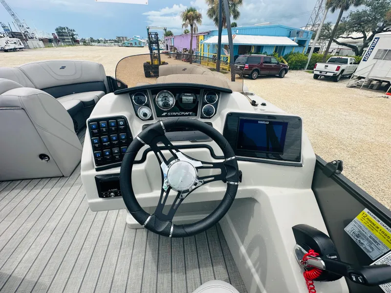 Slide: The Image of 2023 Starcraft CX 23 DL BAR pontoon boat with Yamaha outboard motor, parked outdoors. - 11