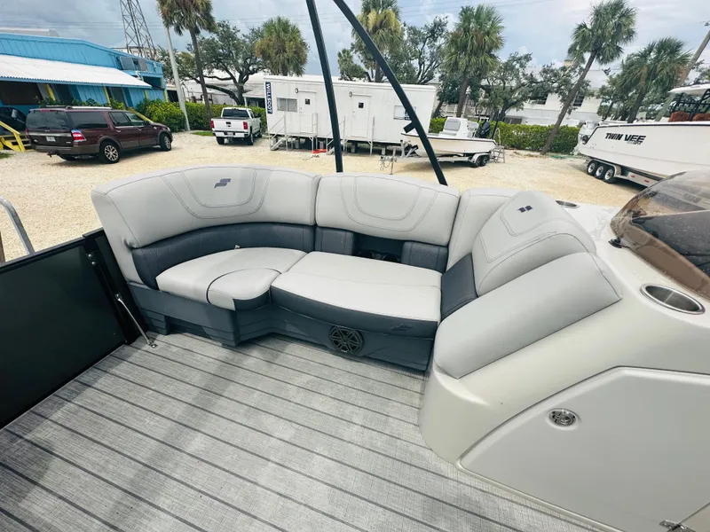 Slide: The Image of 2023 Starcraft CX 23 DL BAR pontoon boat interior with luxurious seating and sleek design. - 14