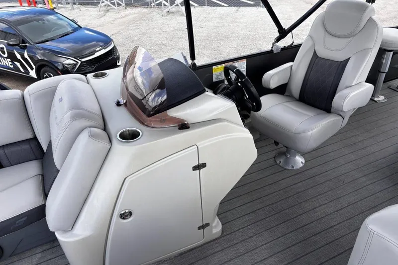 Slide: The Image of 2023 Starcraft CX 23 DL BAR boat interior with plush seating and steering console. - 20