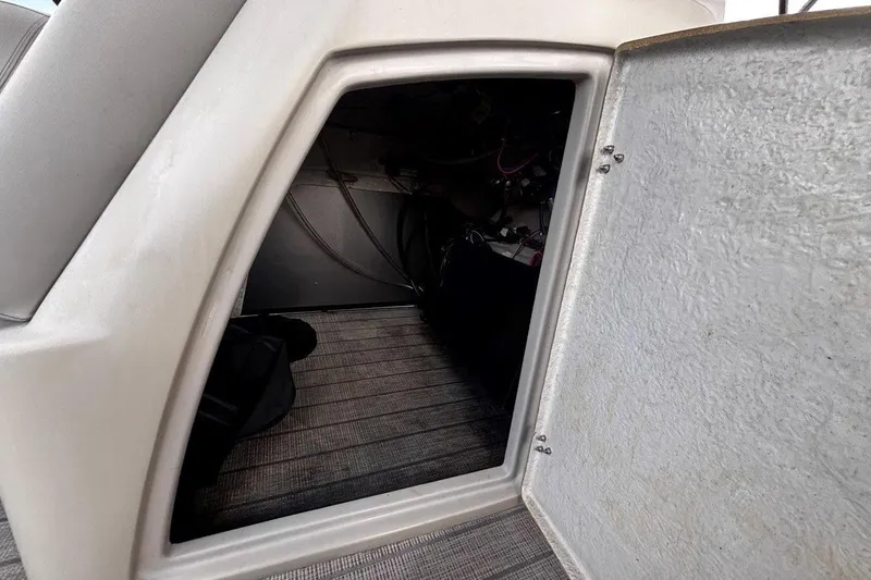 Slide: The Image of Open storage compartment in 2023 Starcraft CX 23 DL BAR boat, showing interior details. - 21