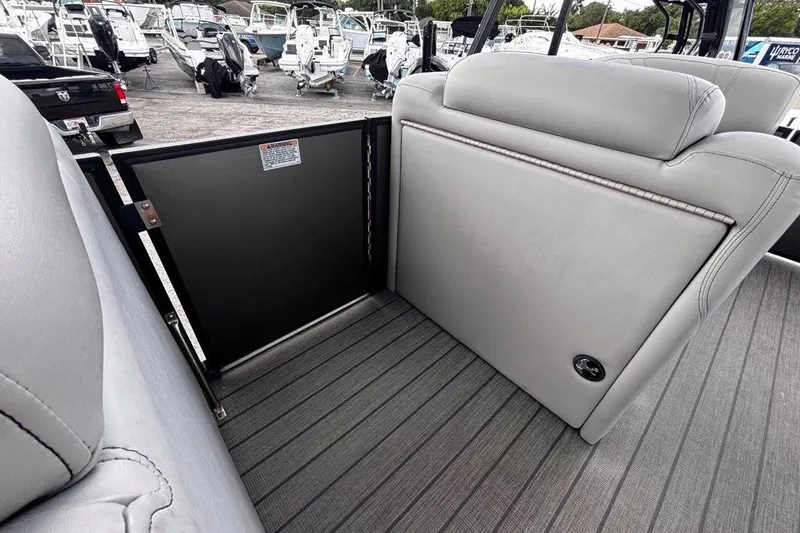 Slide: The Image of 2023 Starcraft CX 23 DL BAR boat interior with gray seating and flooring. - 23