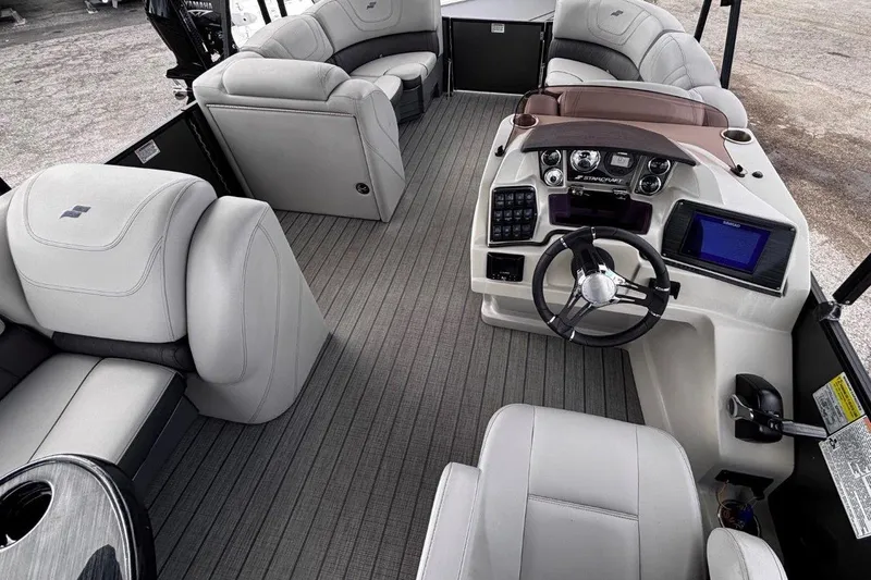 Slide: The Image of 2023 Starcraft CX 23 DL BAR boat interior with modern helm and plush seating. - 25