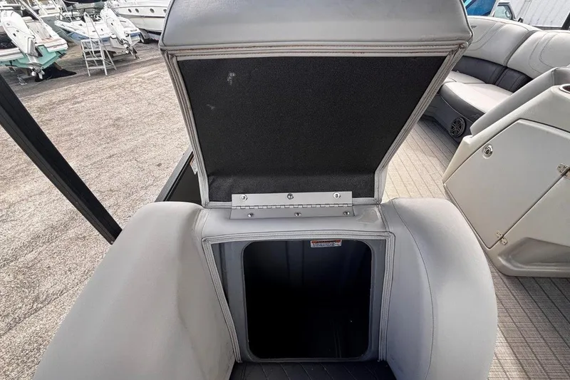 Slide: The Image of 2023 Starcraft CX 23 DL BAR boat with open storage compartment on deck. - 26
