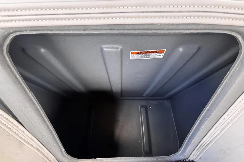 Slide: The Image of Storage compartment in 2023 Starcraft CX 23 DL BAR boat, featuring warning label inside. - 27
