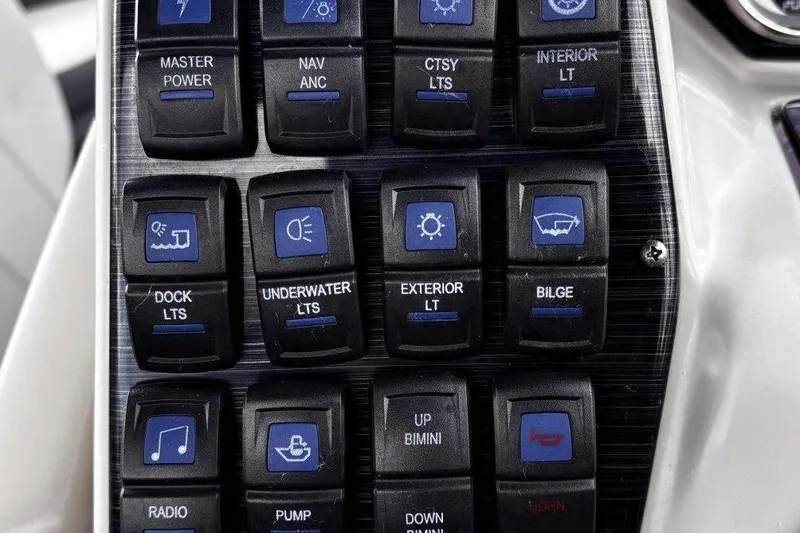 Slide: The Image of Control panel of 2023 Starcraft CX 23 DL BAR boat with labeled switches. - 31