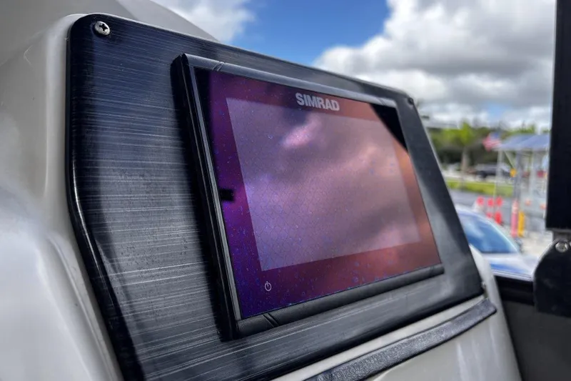 Slide: The Image of Simrad display on 2023 Starcraft CX 23 DL BAR boat, with cloudy sky reflection. - 33