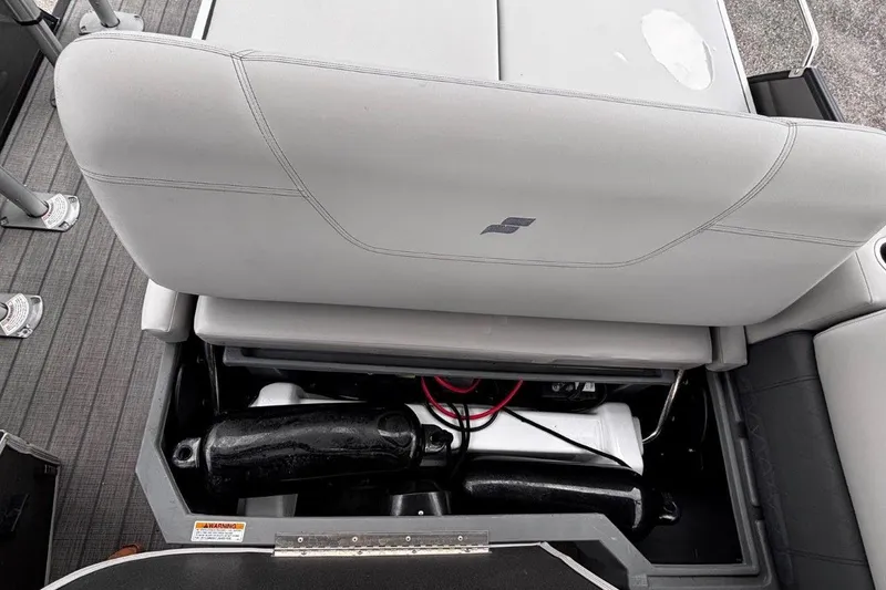 Slide: The Image of 2023 Starcraft CX 23 DL BAR boat seat storage compartment with visible wiring and equipment. - 38