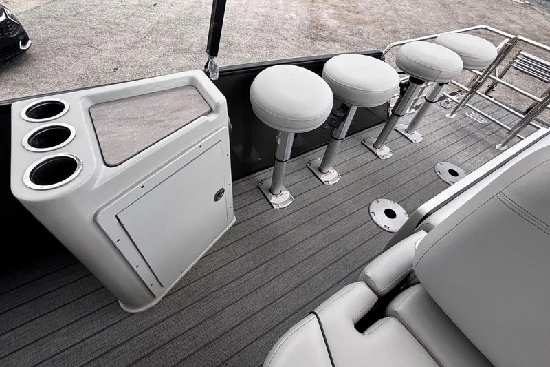 Slide: The Image of 2023 Starcraft CX 23 DL BAR boat interior with bar stools and cup holders. - 39
