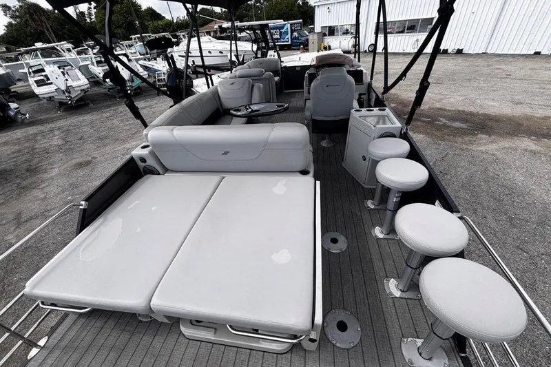 Slide: The Image of 2023 Starcraft CX 23 DL BAR pontoon boat interior with seating and bar stools. - 42