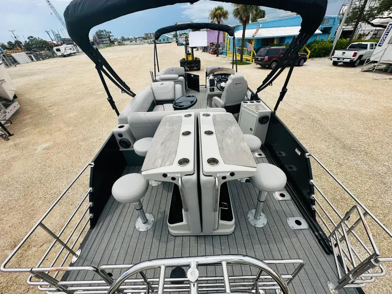 Slide: The Image of 2023 Starcraft CX 23 DL BAR boat with sleek design and logo. - 6