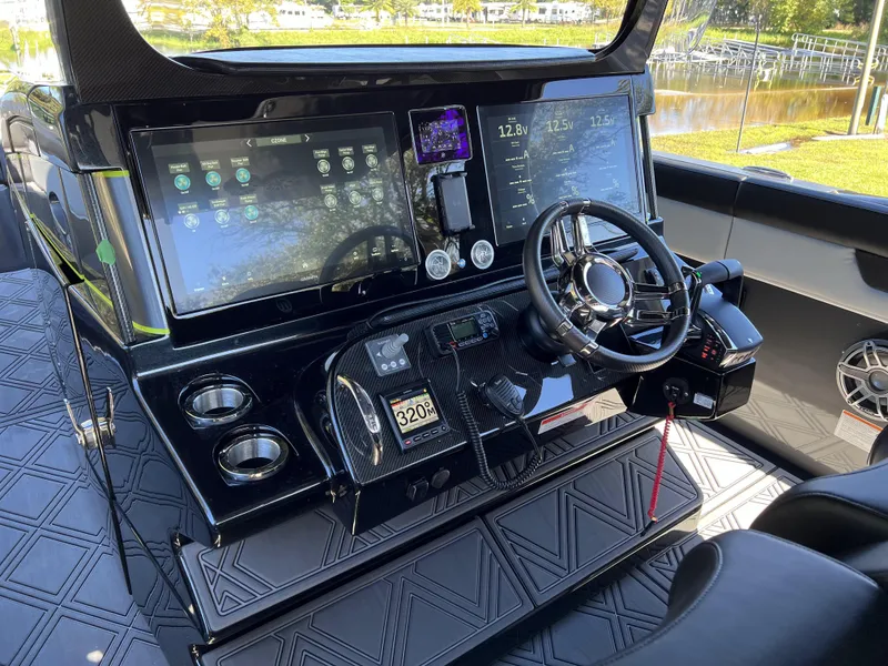 Slide: The Image of 2023 Mystic Powerboats M4200 helm with advanced navigation displays and controls. - 10