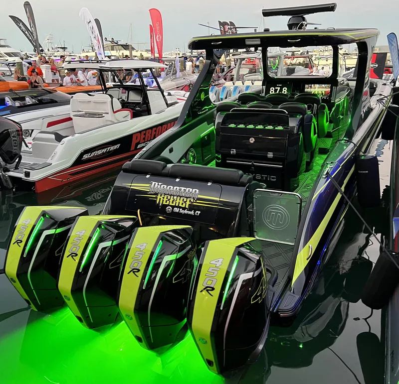 Slide: The Image of 2023 Mystic Powerboats M4200 with quad outboard engines at a boat show. - 14