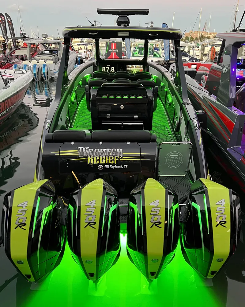 Slide: The Image of 2023 Mystic Powerboats M4200 with quad engines and neon green lighting. - 15