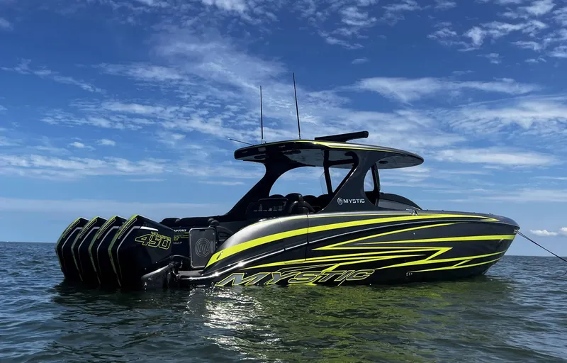 Slide: The Image of 2023 Mystic Powerboats M4200 on water, side view with vibrant graphics. - 3