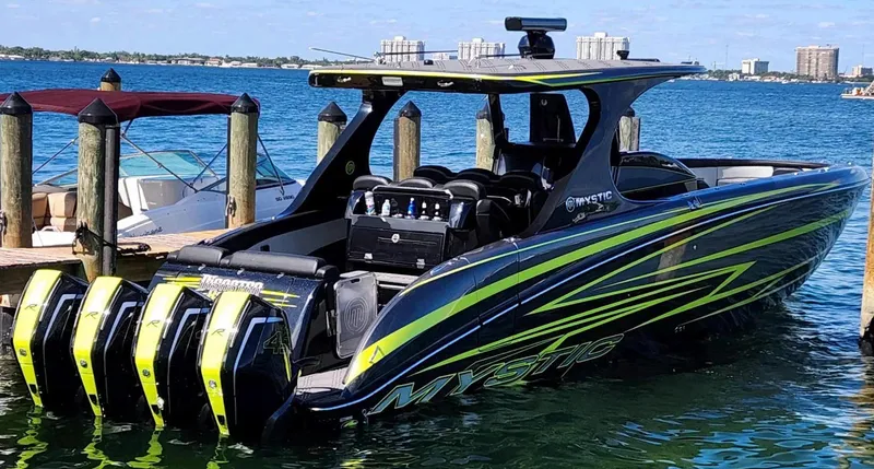 Slide: The Image of 2023 Mystic Powerboats M4200 docked, featuring sleek design and powerful engines. - 4