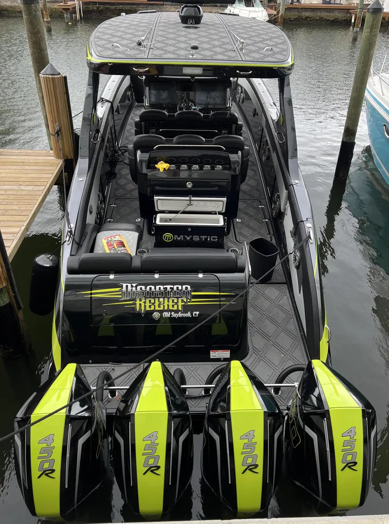 Slide: The Image of 2023 Mystic Powerboats M4200 docked with quad engines. - 7