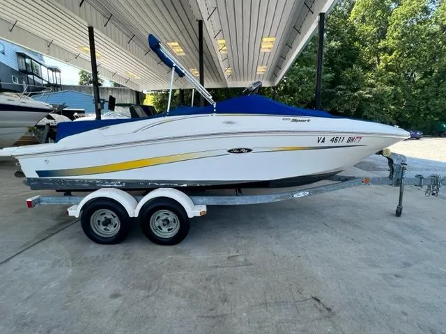 Slide: The Image of 2006 Sea Ray 195 Sport boat on a trailer under a covered dock. - 2
