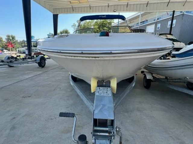 Slide: The Image of 2006 Sea Ray 195 Sport boat on a trailer, front view under a covered area. - 3