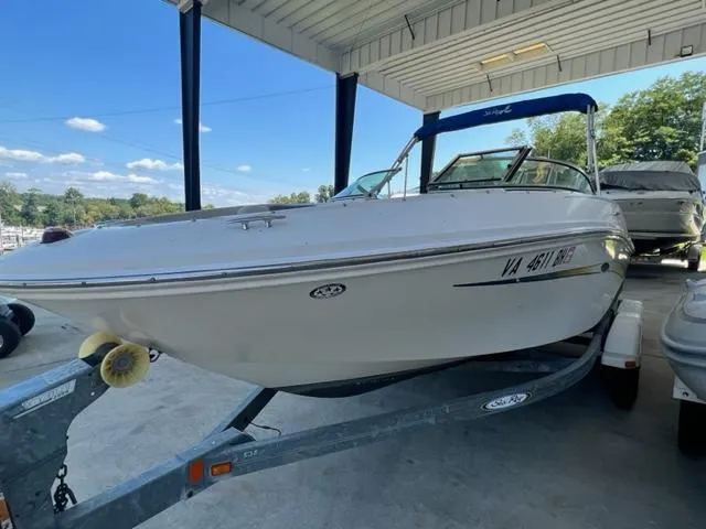 Slide: The Image of 2006 Sea Ray 195 Sport boat on trailer under a covered dock. - 4