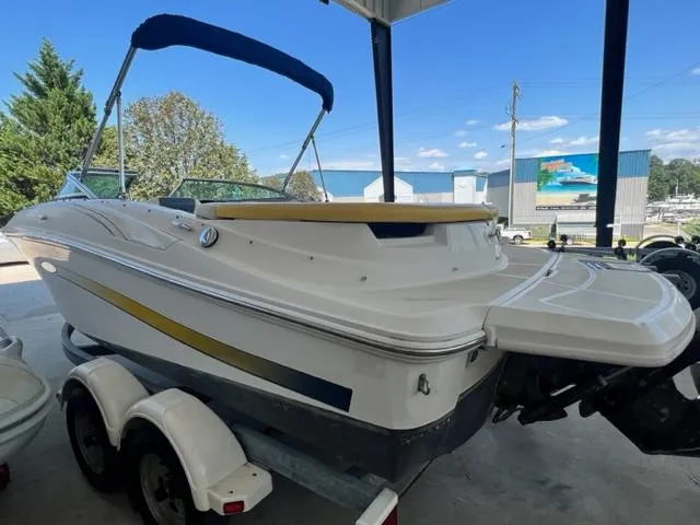 Slide: The Image of 2006 Sea Ray 195 Sport boat on a trailer under a canopy. - 5