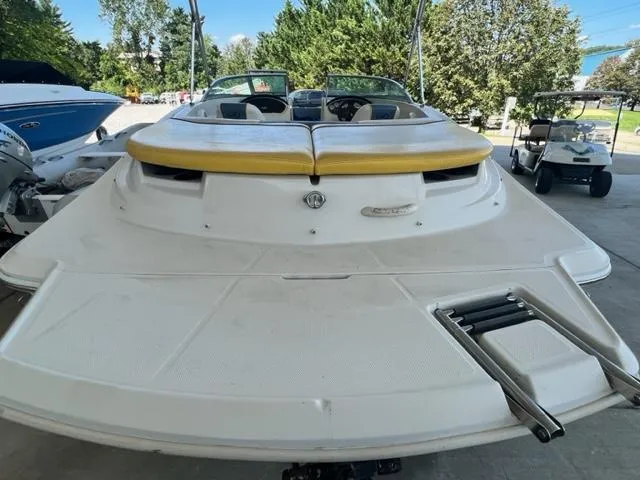 Slide: The Image of 2006 Sea Ray 195 Sport boat with yellow seating, docked in a marina. - 6
