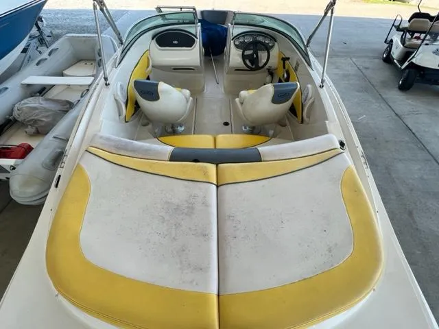Slide: The Image of 2006 Sea Ray 195 Sport boat interior with yellow and white seating. - 7
