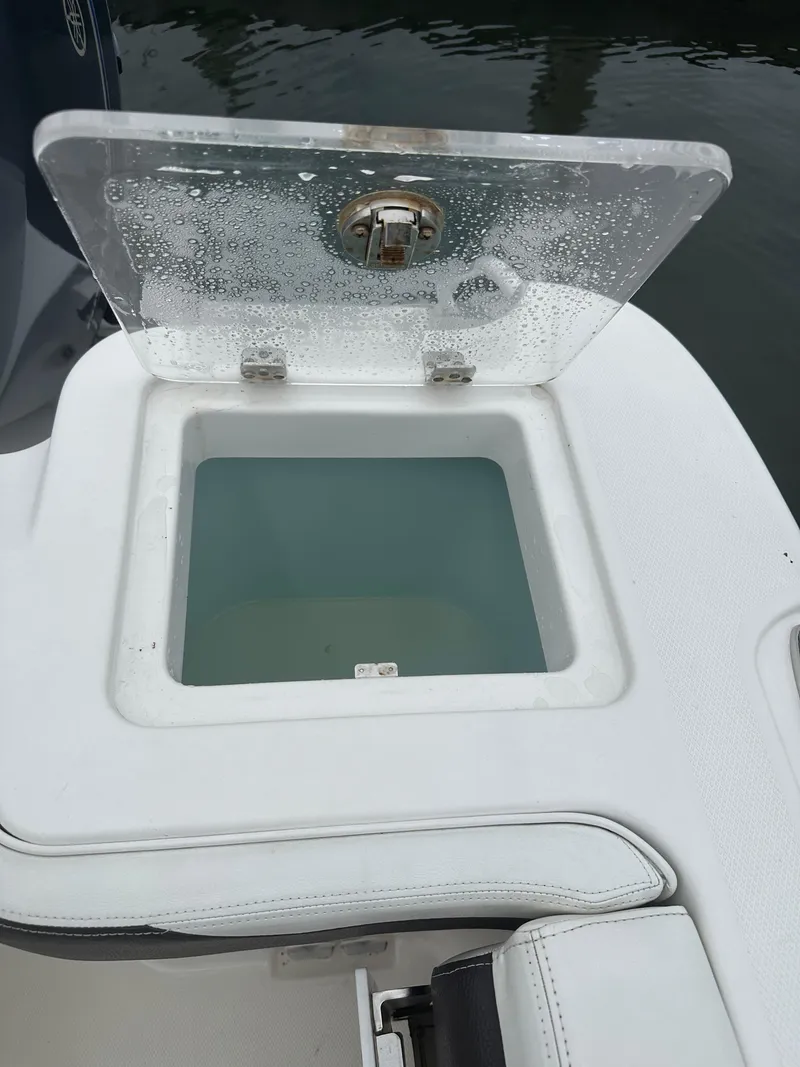 Slide: The Image of 2018 Edgewater 262CX livewell with open lid, showing water inside. - 11