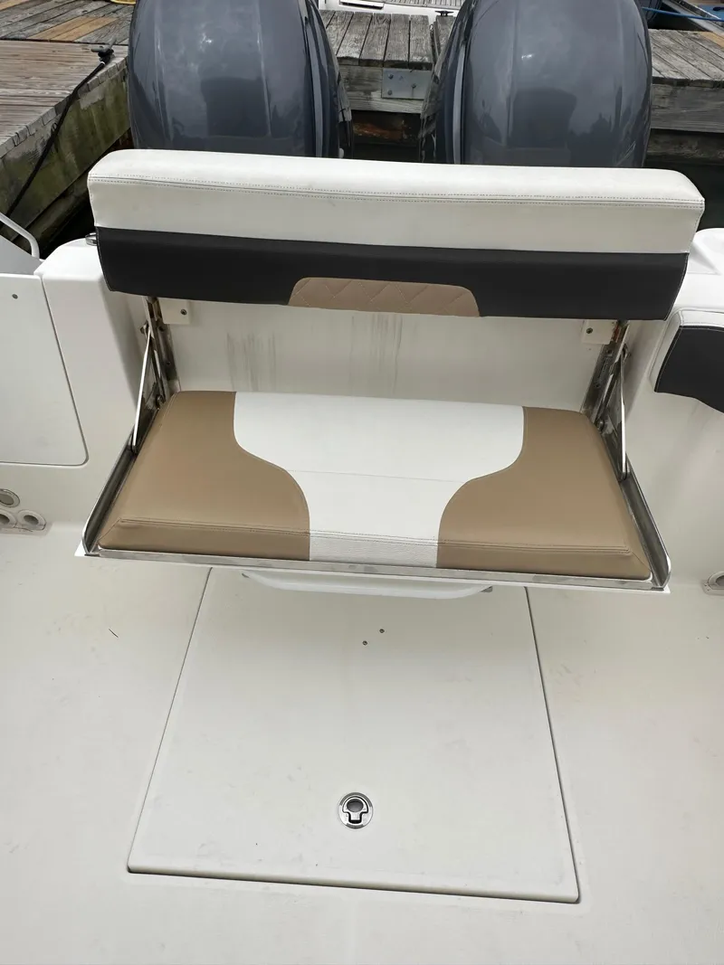 Slide: The Image of 2018 Edgewater 262CX boat with foldable rear seat and twin outboard motors. - 12