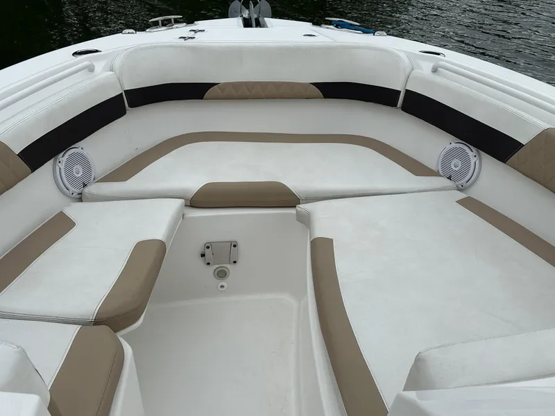 Slide: The Image of 2018 Edgewater 262CX boat interior with cushioned seating and speakers. - 16