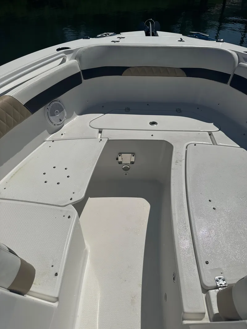 Slide: The Image of 2018 Edgewater 262CX boat interior with seating and storage compartments. - 17