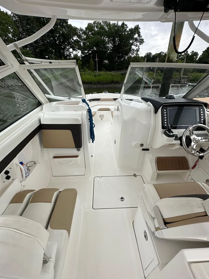 Slide: The Image of 2018 Edgewater 262CX boat interior with seating and control panel. - 18