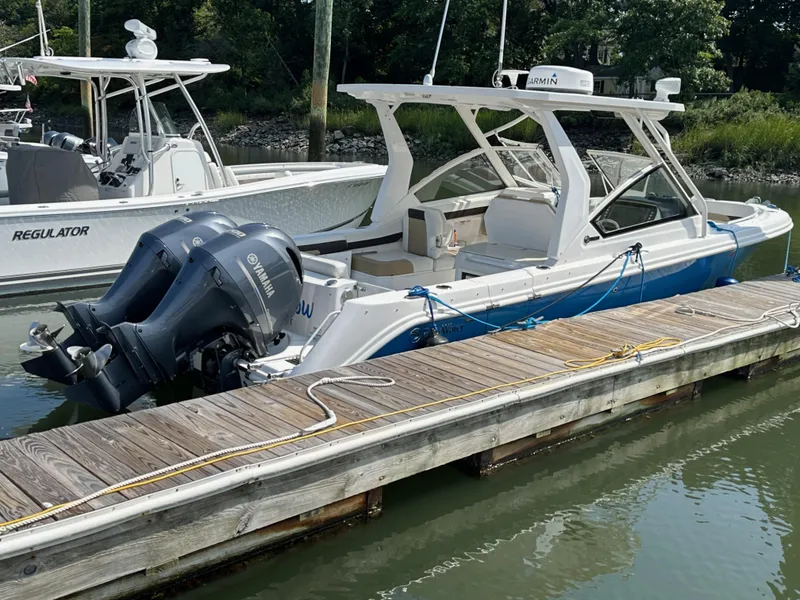 Slide: The Image of 2018 Edgewater 262CX boat docked with twin Yamaha outboard engines. - 23
