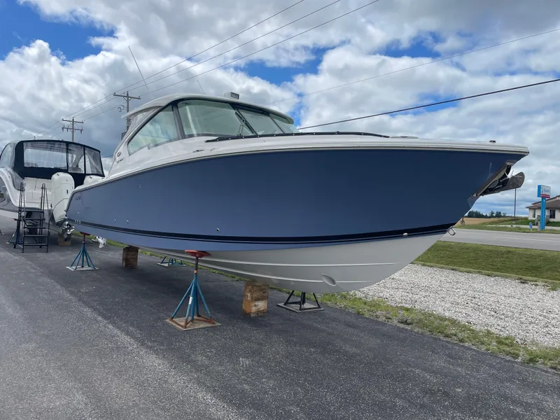 Slide: The Image of 2024 Pursuit DC 326 Dual Console boat on display under cloudy sky. - 0