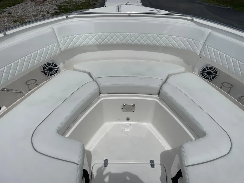 Slide: The Image of 2024 Pursuit DC 326 Dual Console boat interior with white cushioned seating. - 19