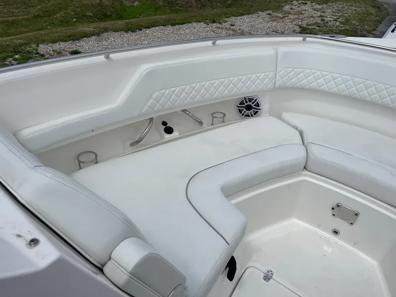 Slide: The Image of 2024 Pursuit DC 326 Dual Console boat with white cushioned seating and cup holders. - 20