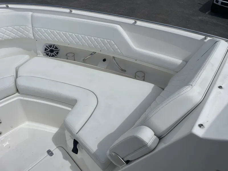 Slide: The Image of 2024 Pursuit DC 326 Dual Console boat with white cushioned seating area. - 21