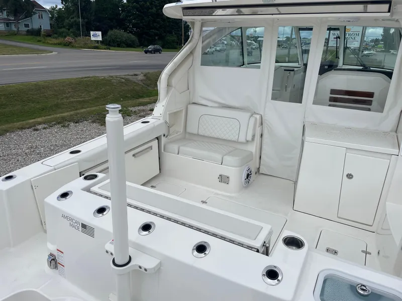 Slide: The Image of 2024 Pursuit DC 326 Dual Console boat interior with seating and storage compartments. - 5