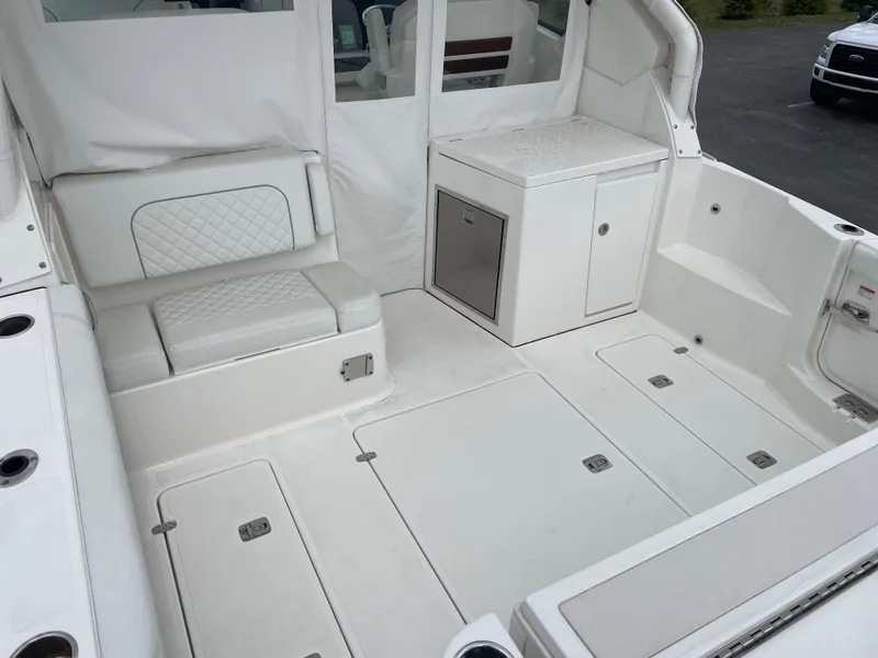 Slide: The Image of 2024 Pursuit DC 326 Dual Console boat interior with seating and storage. - 6
