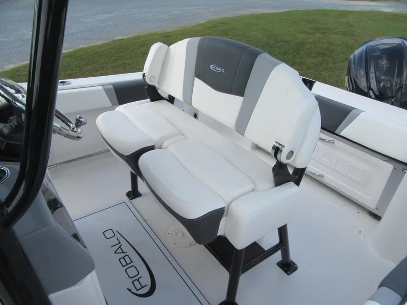Slide: The Image of 2024 Robalo R230 Center Console boat seating, white and gray upholstery. - 11