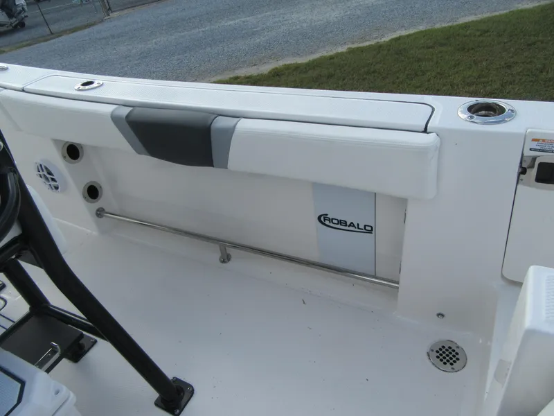 Slide: The Image of 2024 Robalo R230 Center Console boat interior, featuring sleek white design and modern amenities. - 14