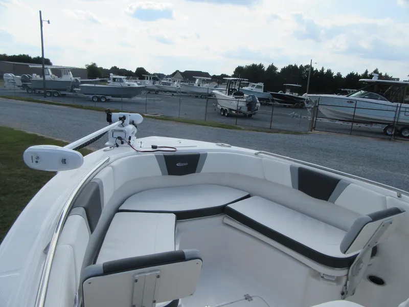 Slide: The Image of 2024 Robalo R230 Center Console boat with spacious seating in a marina setting. - 4