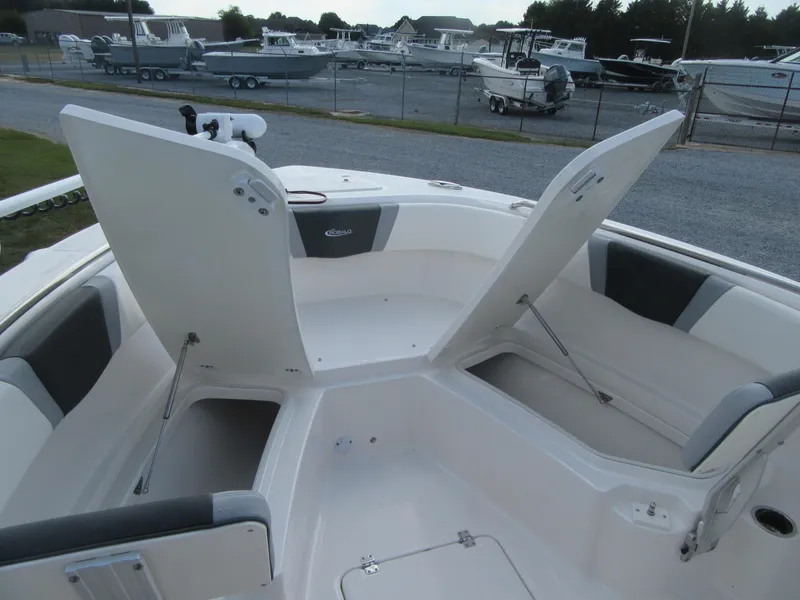 Slide: The Image of 2024 Robalo R230 Center Console boat with open storage compartments. - 7