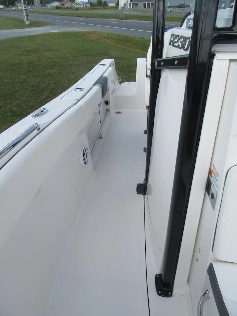 Slide: The Image of 2024 Robalo R230 Center Console boat deck, featuring sleek design and spacious layout. - 9