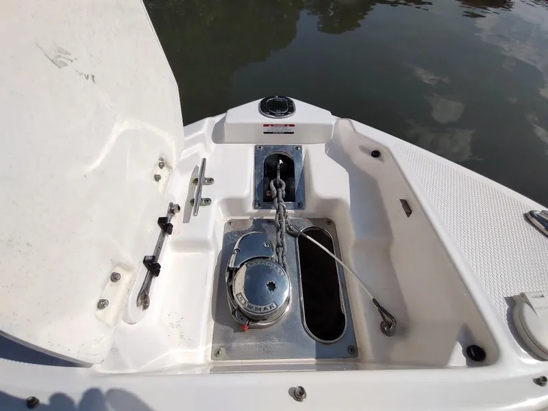 Slide: The Image of 2018 Chaparral 267 SSX boat anchor compartment with chain and winch. - 13