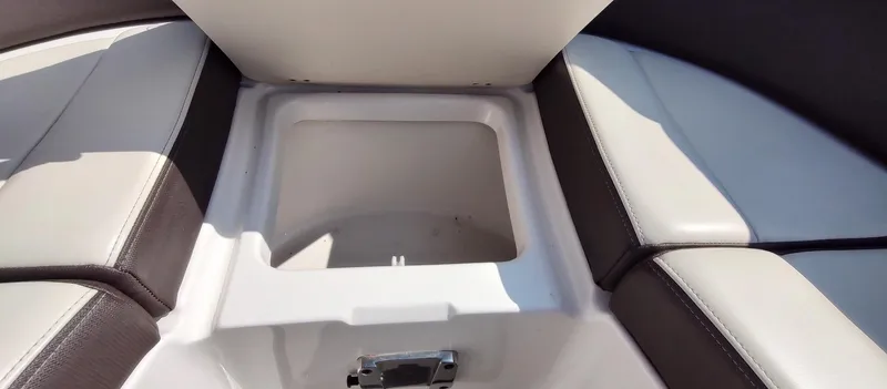 Slide: The Image of 2018 Chaparral 267 SSX boat storage compartment with cushioned seating. - 15