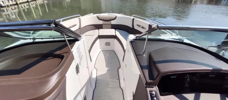 Slide: The Image of 2018 Chaparral 267 SSX boat interior with brown seating and open bow design. - 19