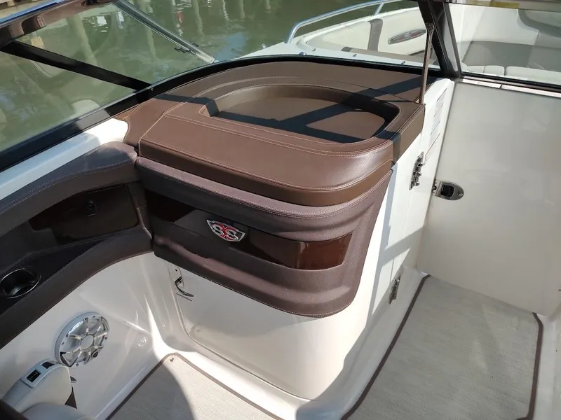 Slide: The Image of 2018 Chaparral 267 SSX boat interior with brown leather accents and speaker. - 21