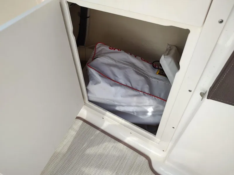 Slide: The Image of Storage compartment on a 2018 Chaparral 267 SSX boat with a safety gear bag. - 29