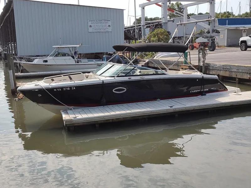 Slide: The Image of 2018 Chaparral 267 SSX boat docked at marina, side view. - 3