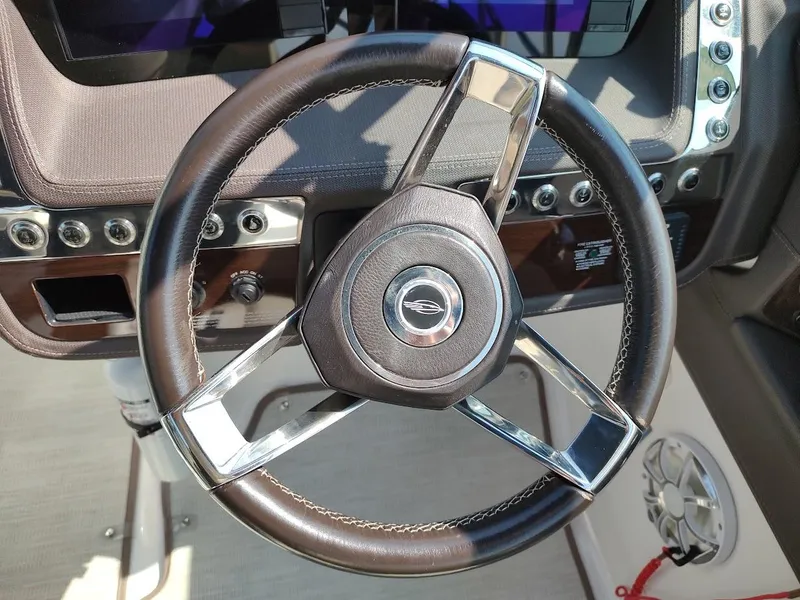 Slide: The Image of Steering wheel of 2018 Chaparral 267 SSX boat, featuring sleek design and modern controls. - 32